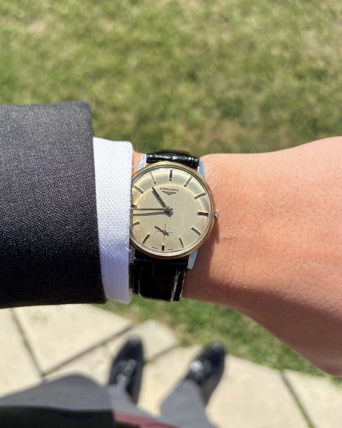 Vintage Longines on the wrist with a grey suit